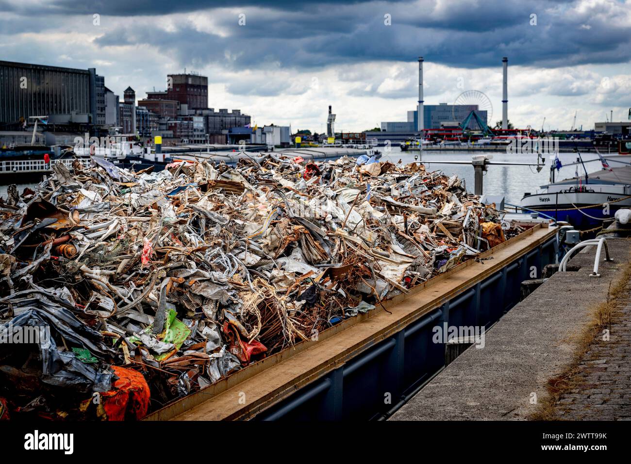 ROTTERDAM - An inland vessel loaded with old iron and metal scrap. Stock Photo