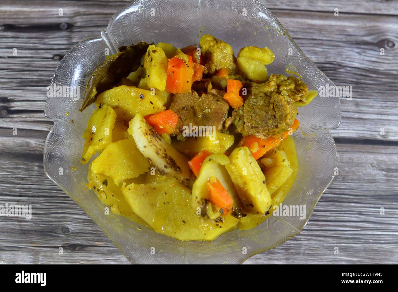 Baked potato slices, onion, carrot, pieces of beef meat, zucchini, spices, garlic, paprika and laurel,  potatoes with beef meat and vegetables baked T Stock Photo