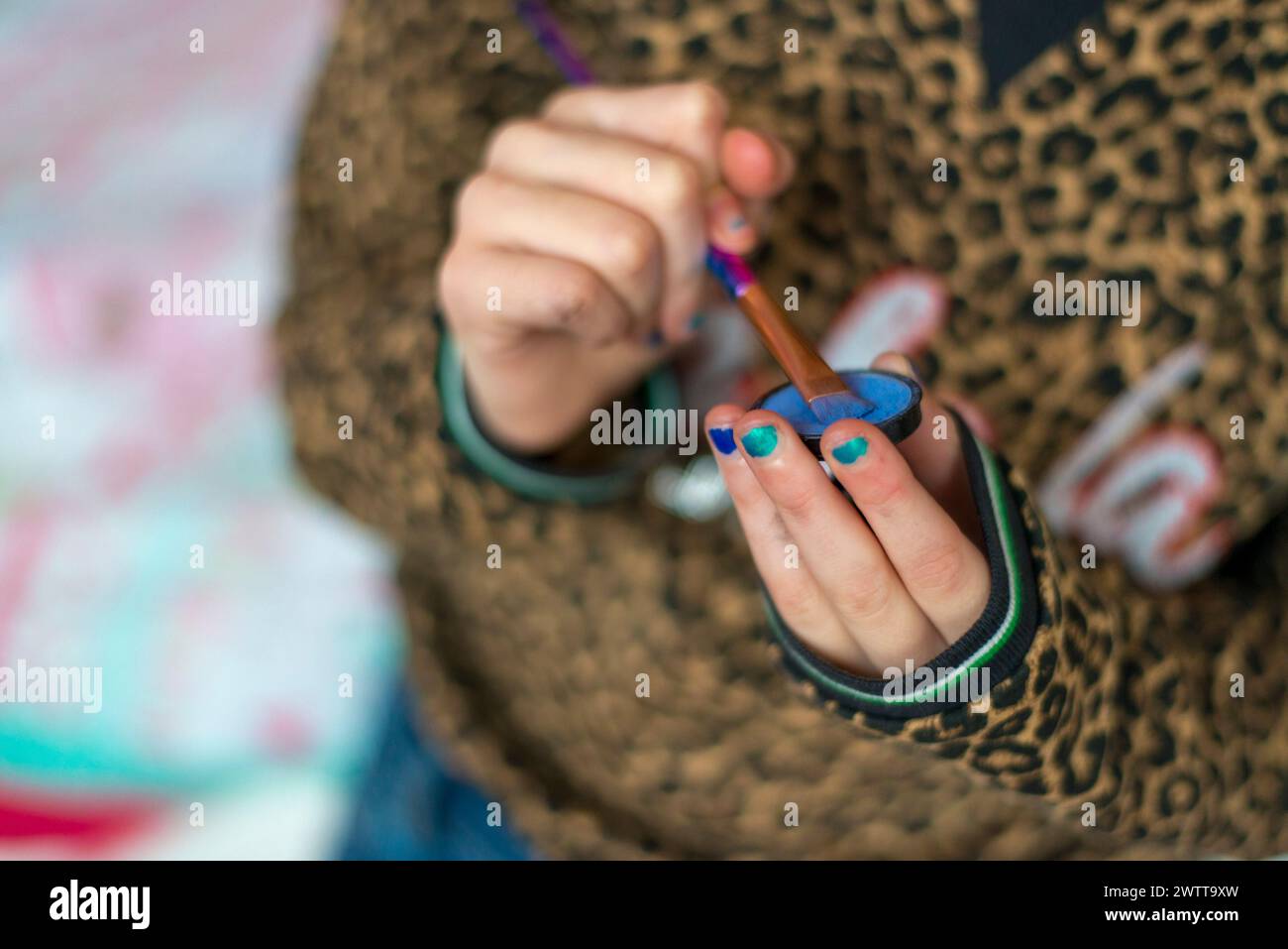 Closeup of hands playing with a miniature slingshot. Stock Photo