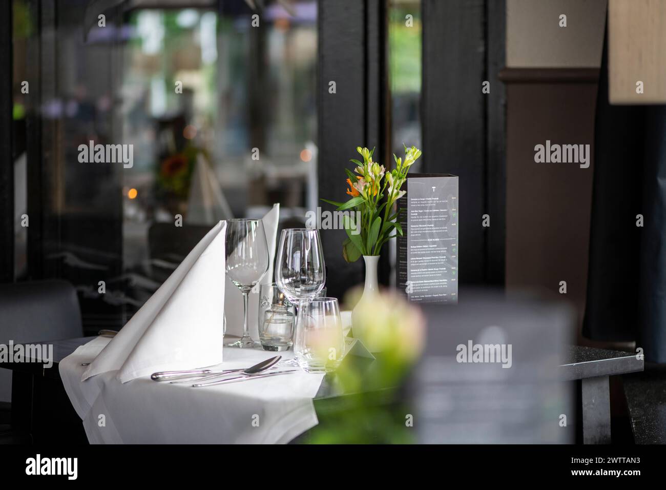 Elegant table setting at a sidewalk cafe, awaiting guests. Stock Photo