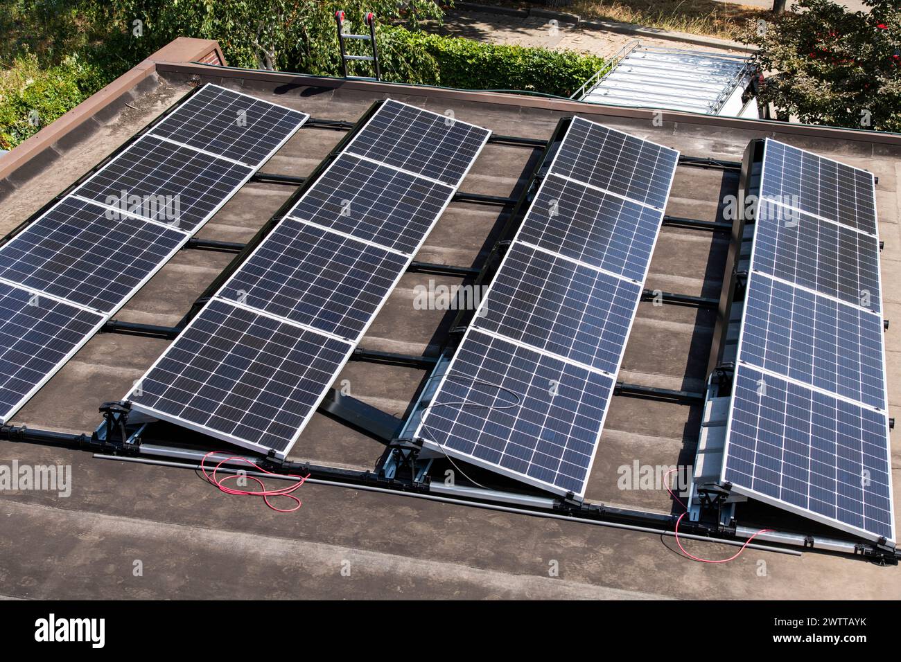 Solar panels soaking up the sun on a rooftop Stock Photo