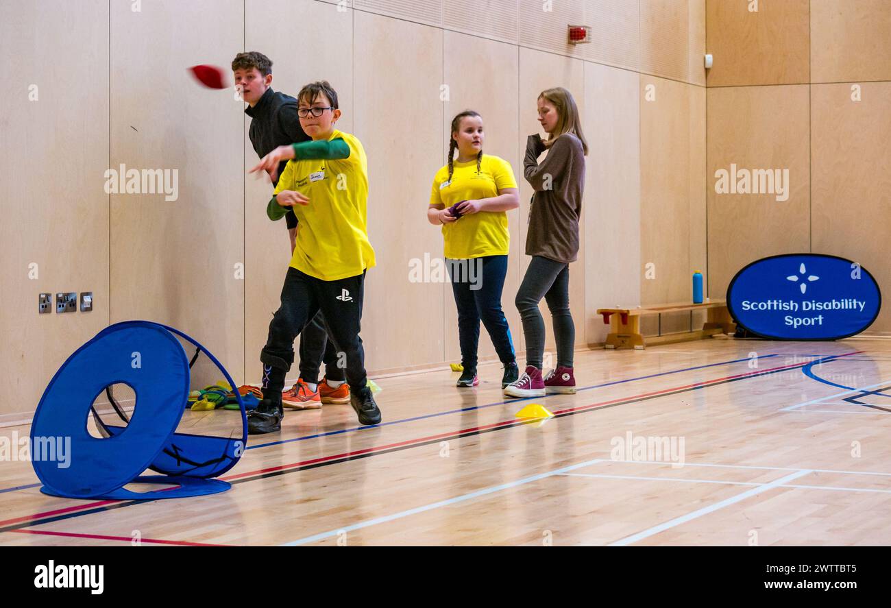 Winchburgh Academy, West Lothian, Scotland, UK, 19th March 2024. Parasport Festival for children with disabilities: Scottish Disability Sport is holding a series of countrywide events to offer young people with physical disabilities, hearing loss and vision impairments an opportunity to try a wide range of sports delivered by local qualified coaches. Pictured: Jamie Carter, who is 13 years old and has a hemiplegia in an athletics session. Credit: Sally Anderson/Alamy Live News Stock Photo