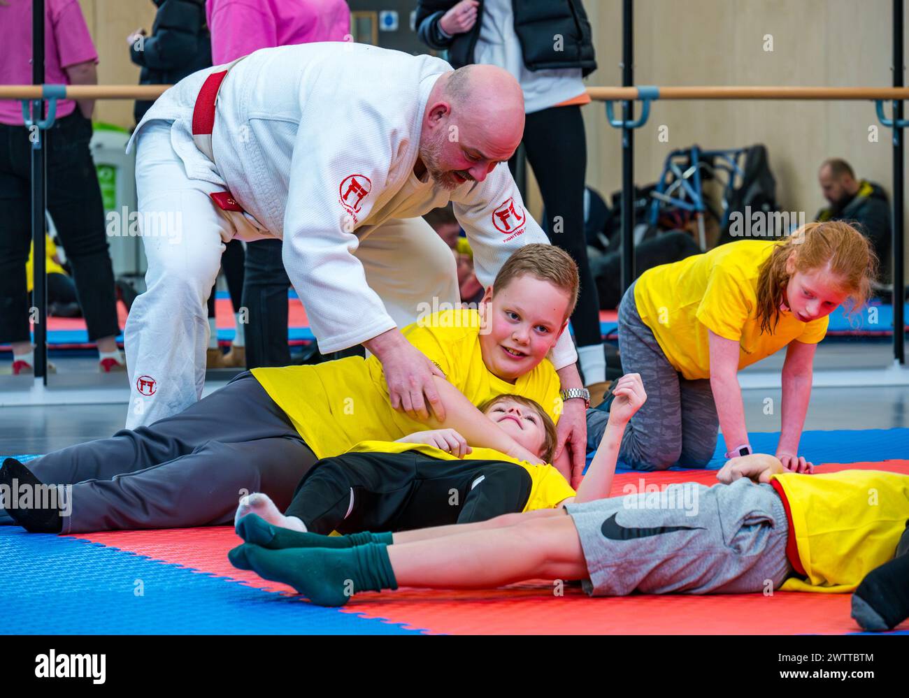 Winchburgh Academy, West Lothian, Scotland, UK, 19th March 2024. Parasport Festival for children with disabilities: Scottish Disability Sport is holding a series of countrywide events to offer young people with physical disabilities, hearing loss and vision impairments an opportunity to try a wide range of sports delivered by local qualified coaches. Pictured: children in a judo session. Credit: Sally Anderson/Alamy Live News Stock Photo