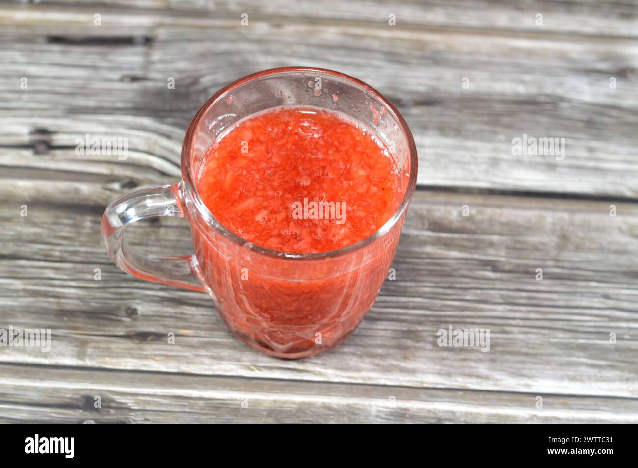 Fresh Strawberry fruit juice, the garden strawberry is a widely grown hybrid species of the genus Fragaria ananassa with its characteristic aroma, bri Stock Photo