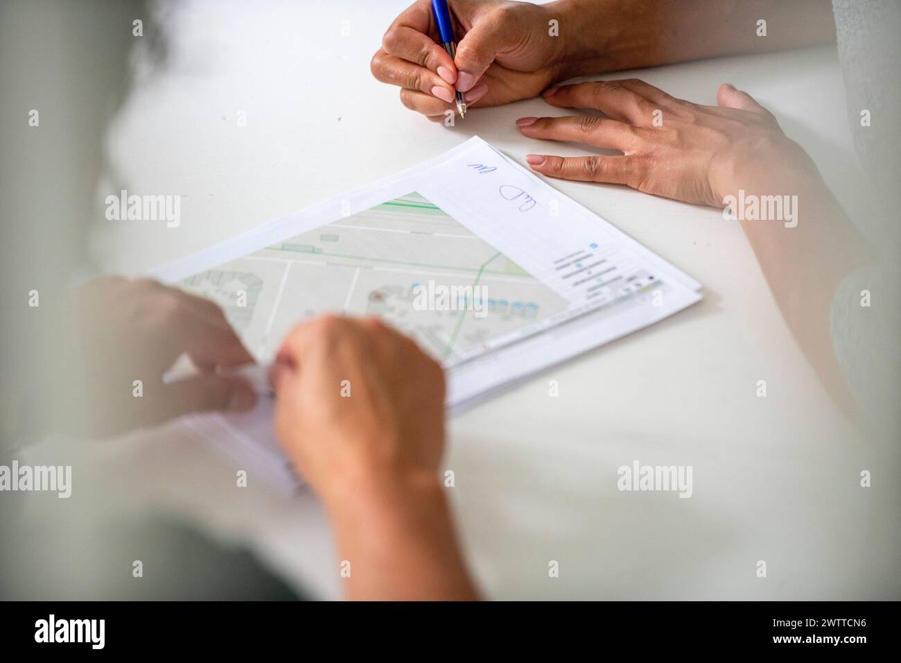 Two people collaborating over a project plan Stock Photo
