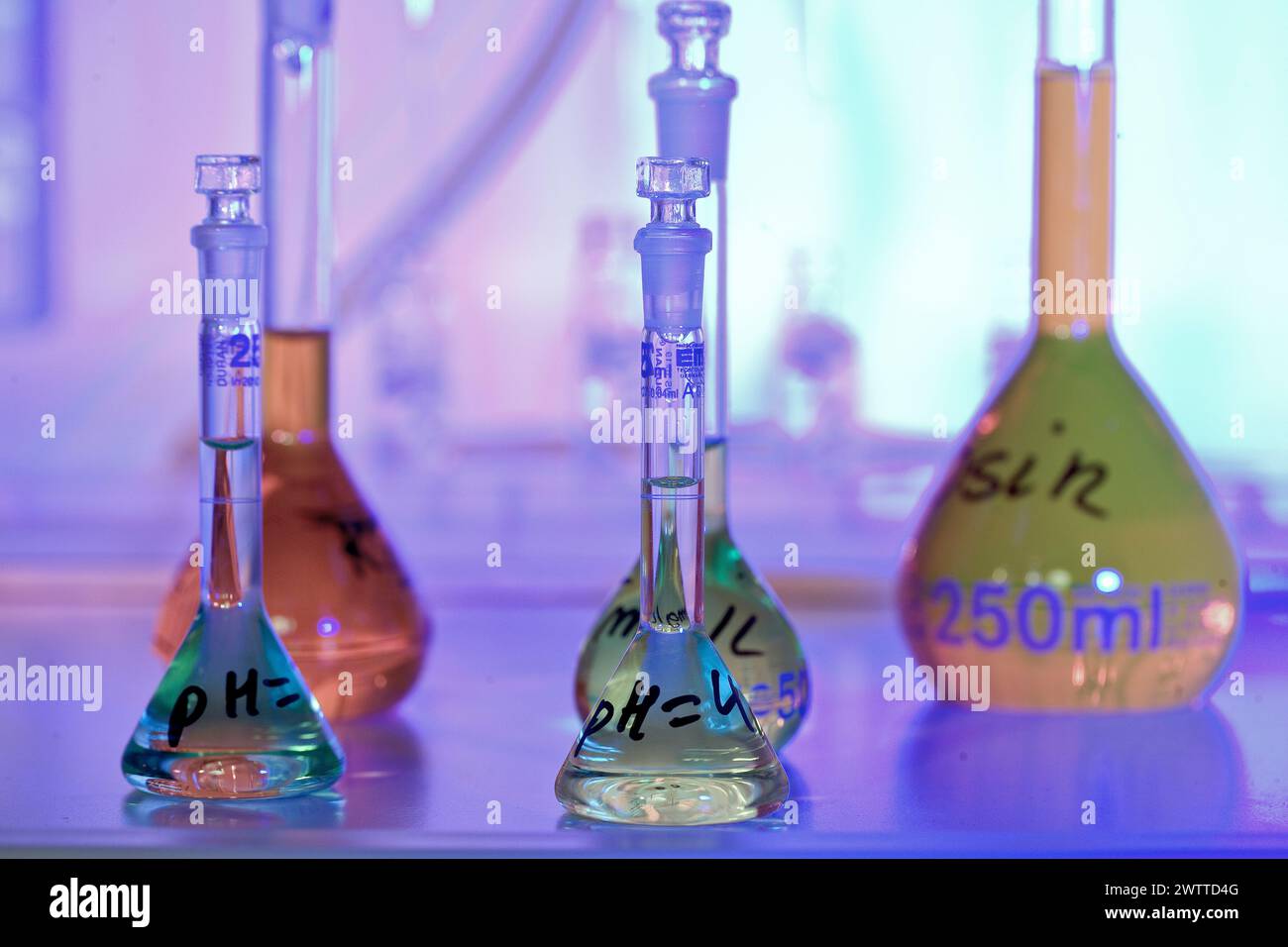 A colorful chemistry scene with various glassware Stock Photo