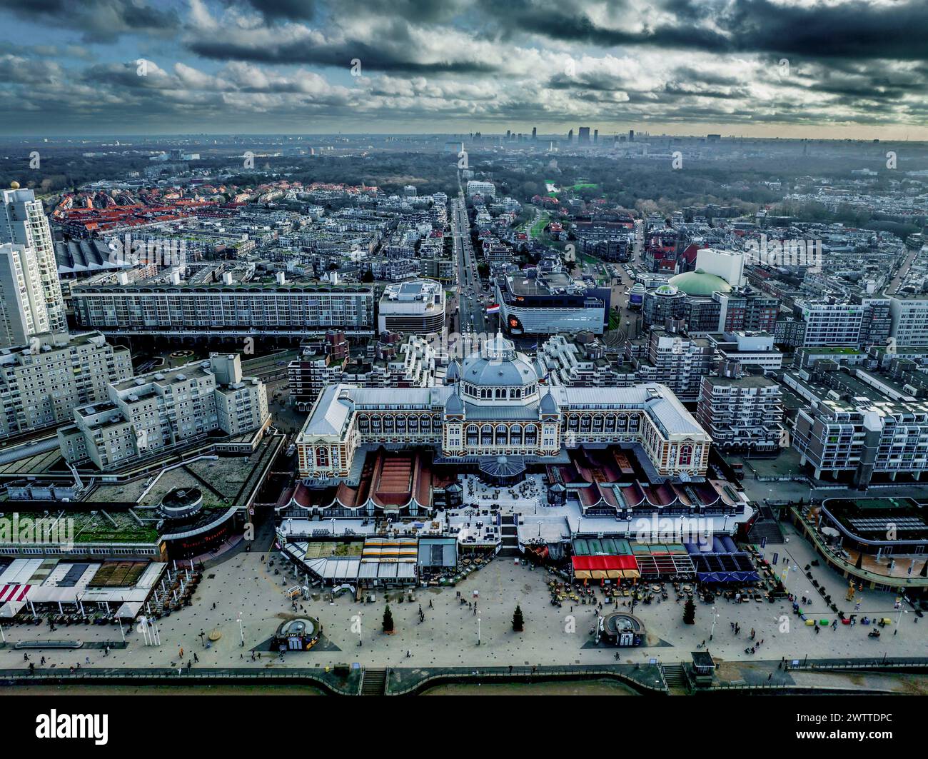 Aerial view of a bustling city center at dusk with dramatic clouds Stock Photo