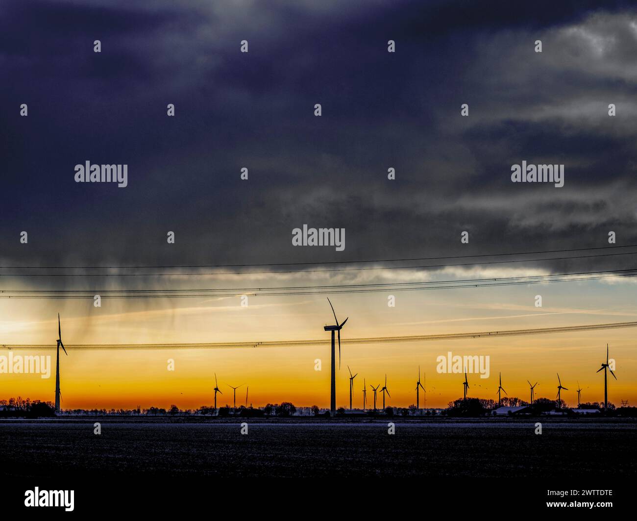 Dramatic sunset behind a silhouette of wind turbines Stock Photo - Alamy