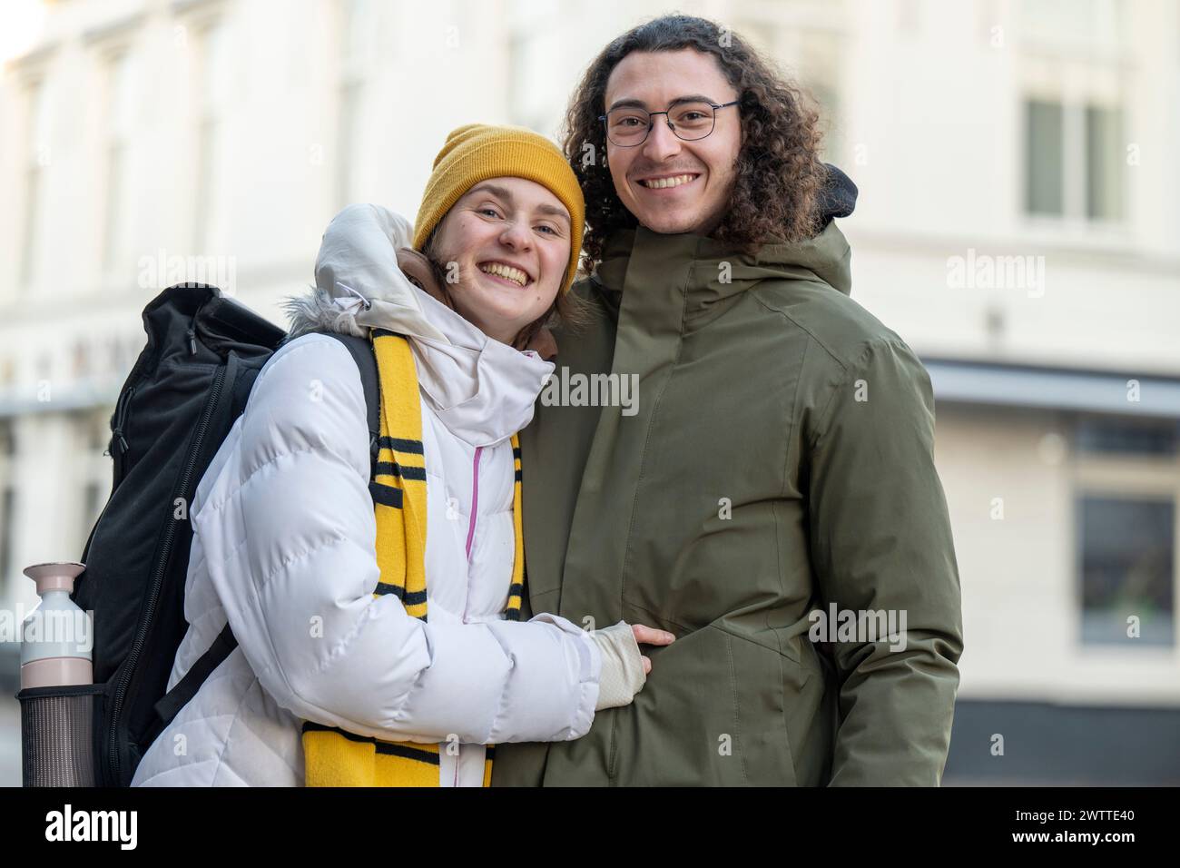Two friends sharing a joyful moment on a city street. Stock Photo