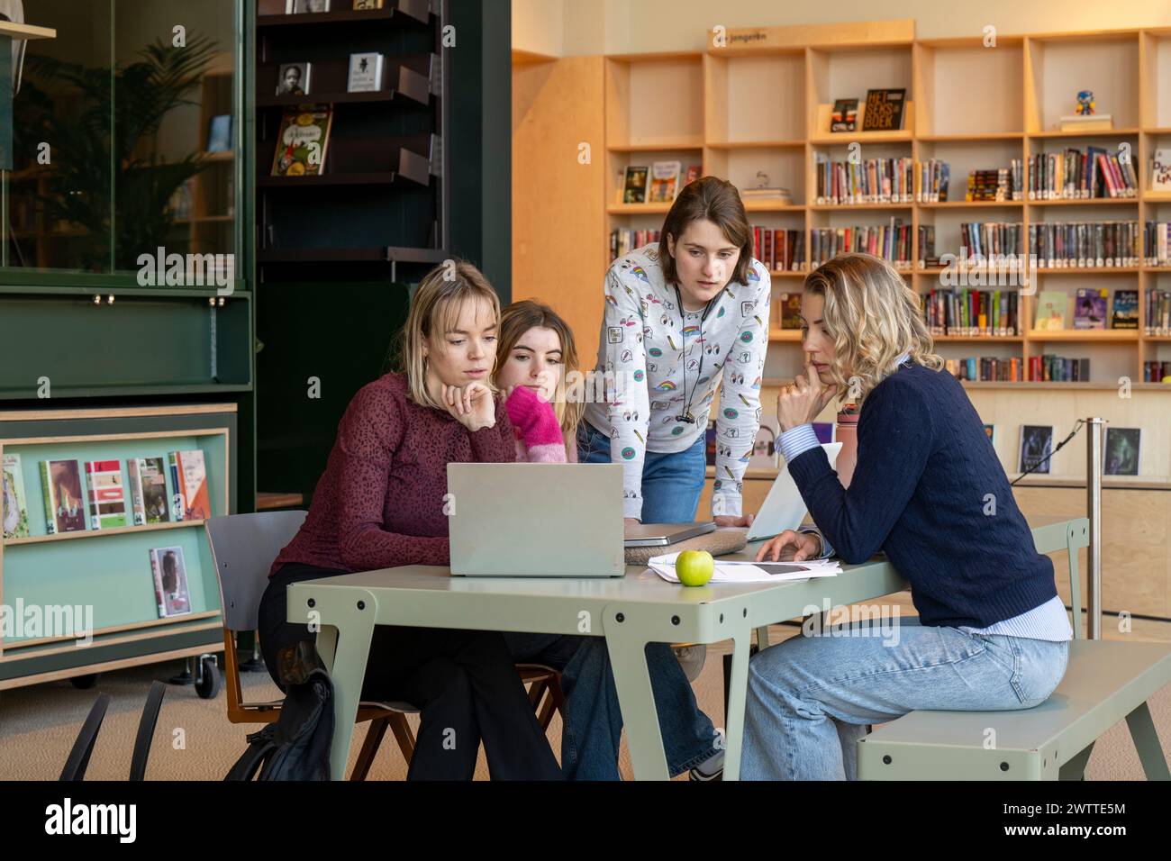 Group of students collaborating on a project in a library Stock Photo