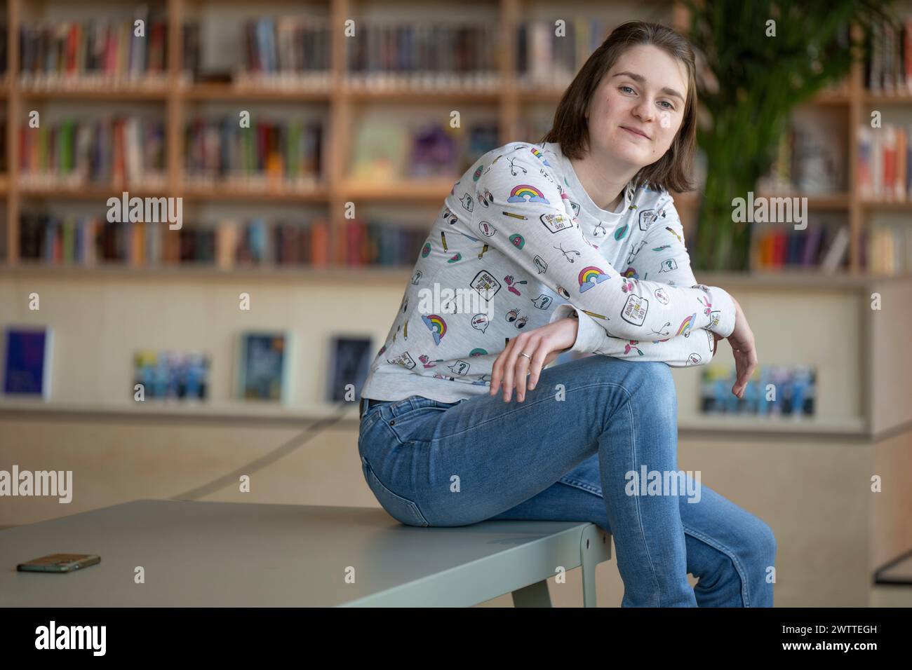 Casual moment captured of a young person lounging with a thoughtful expression. Stock Photo