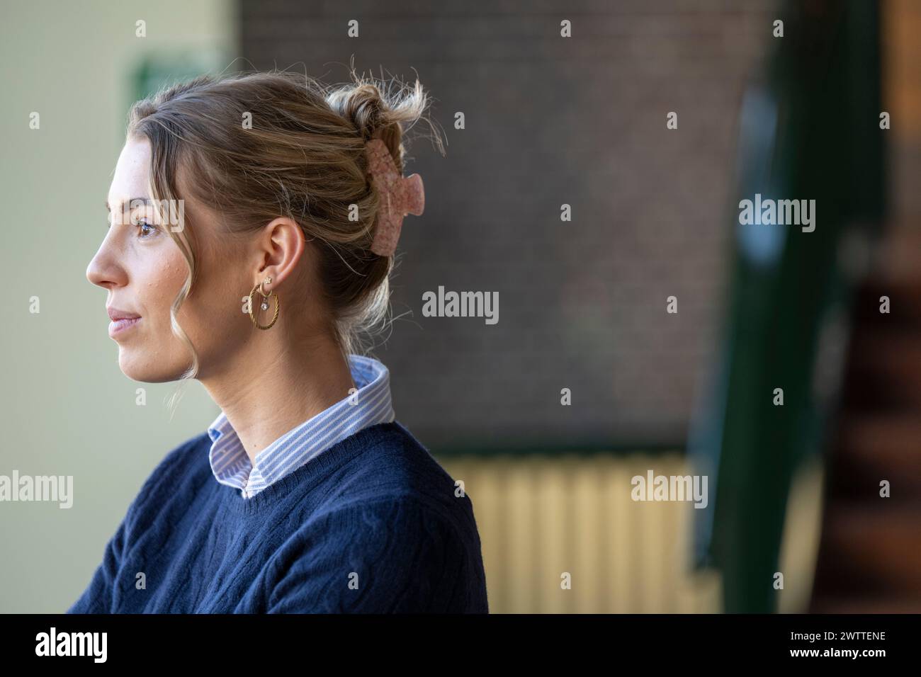 Woman in contemplative profile view outdoors Stock Photo