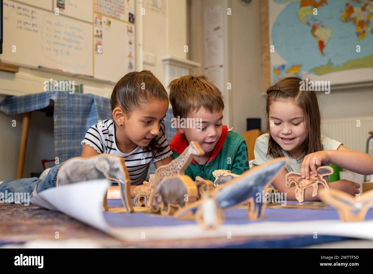 Children engaged in discovering the animal kingdom together Stock Photo
