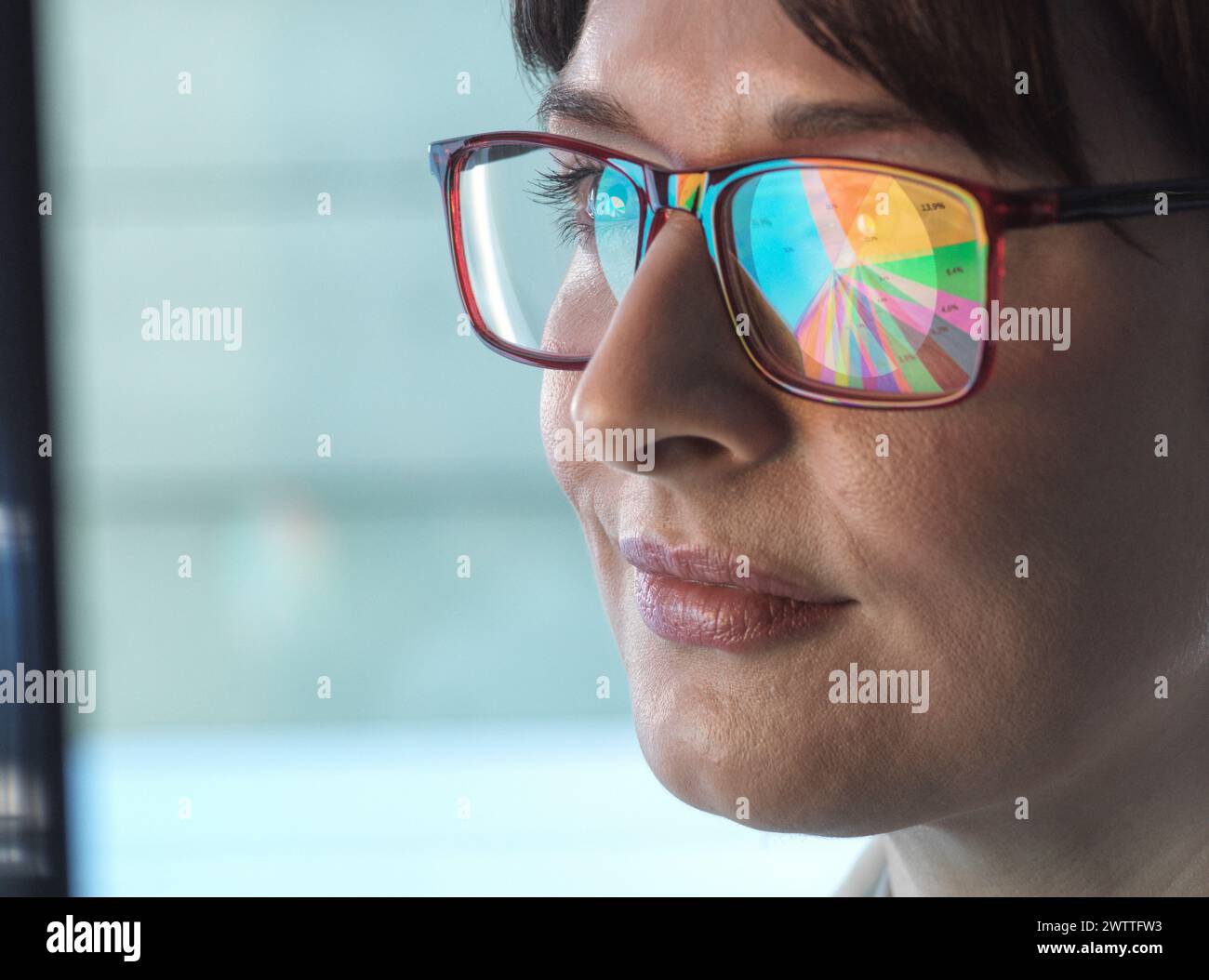 Professional women designing a pie diagram on a computer to illustrate business statistics. Stock Photo