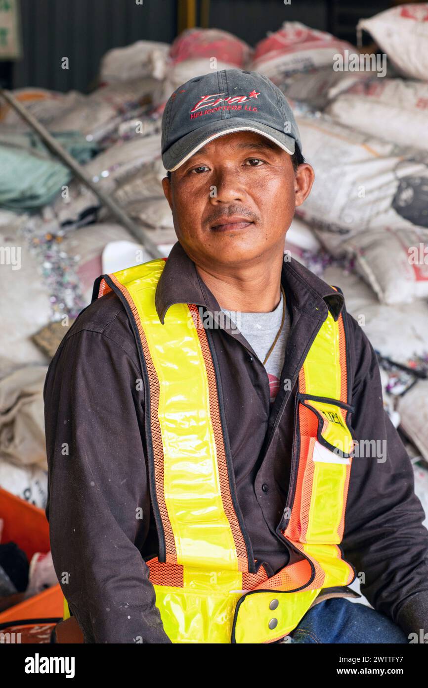 Young reflective vest sitting amidst industrial materials plastic ...