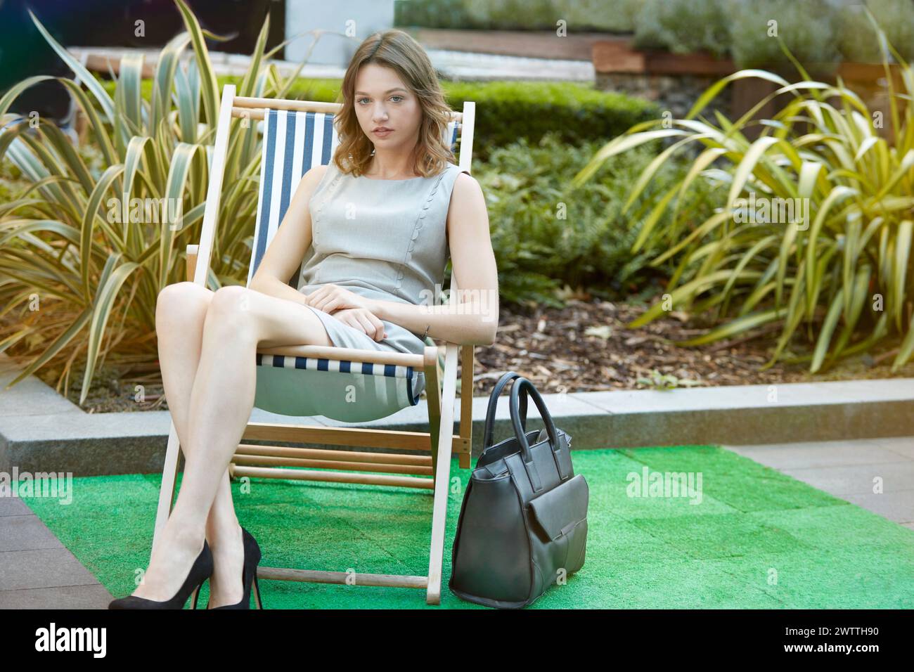 Woman dress sitting chair hi-res stock photography and images - Alamy