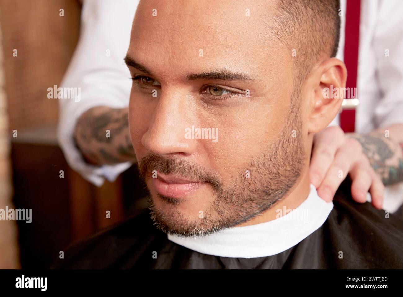 Man getting a haircut at a barbershop Stock Photo