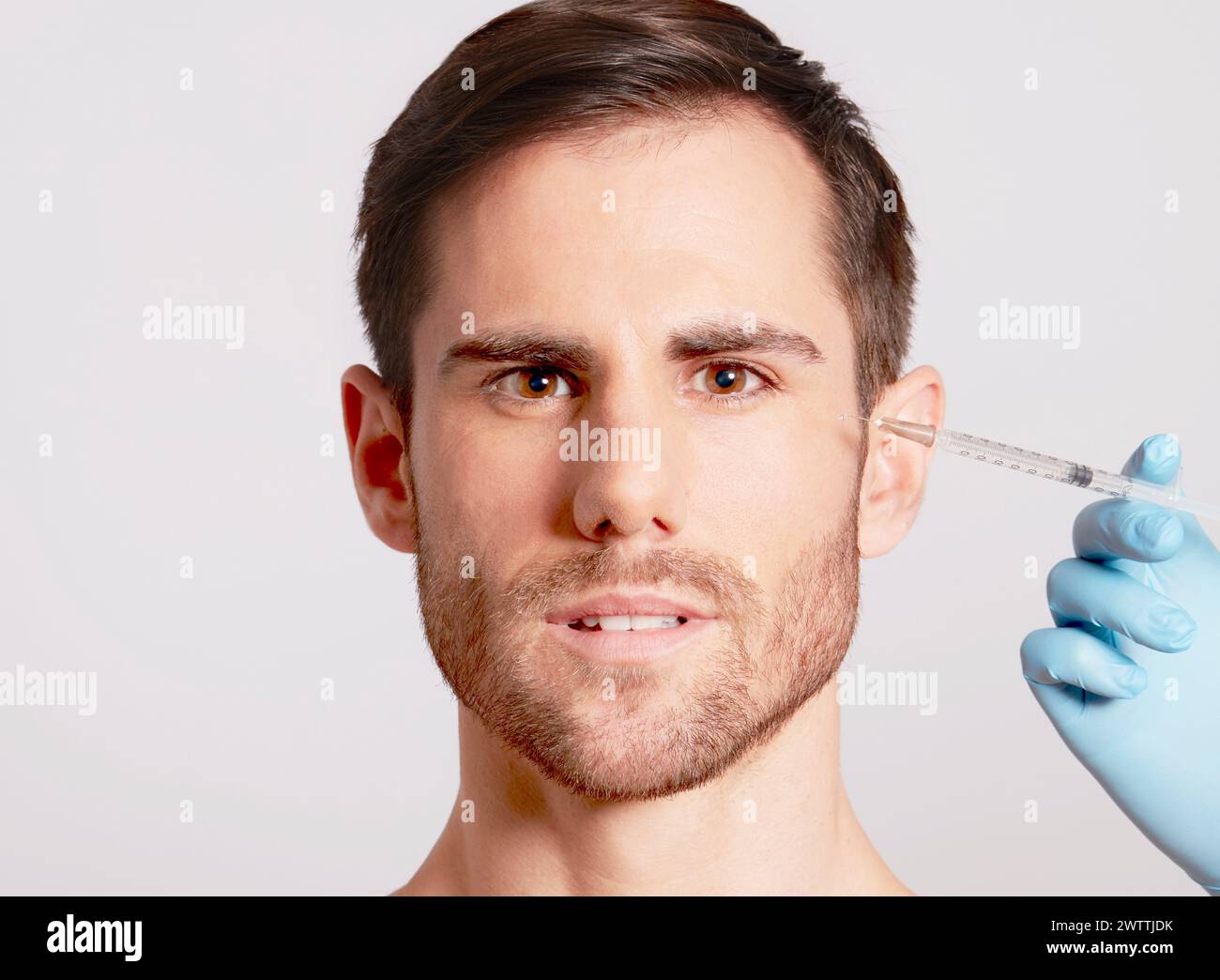 Man receiving injection near the forehead Stock Photo
