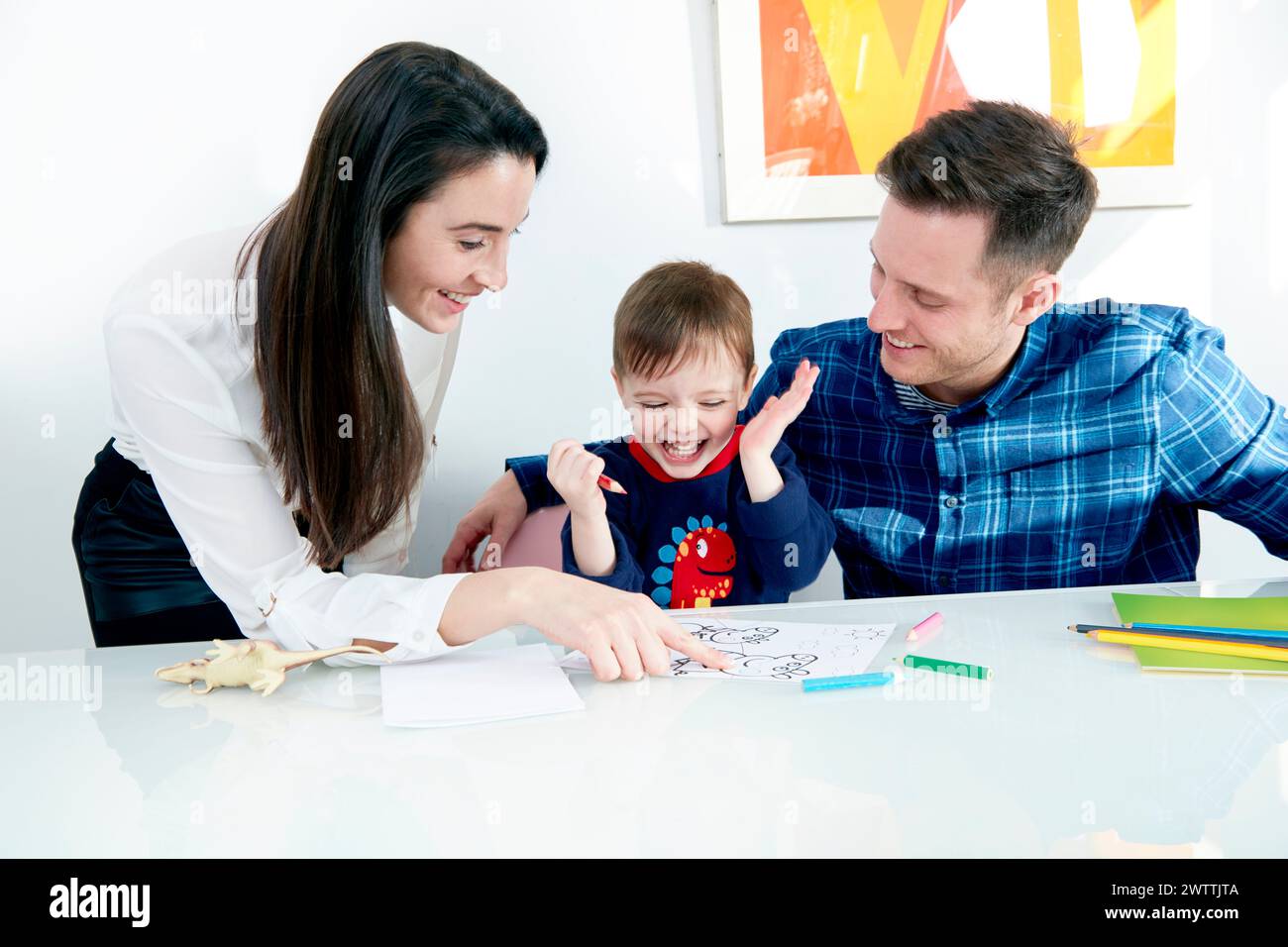 Family enjoying coloring activity together Stock Photo - Alamy
