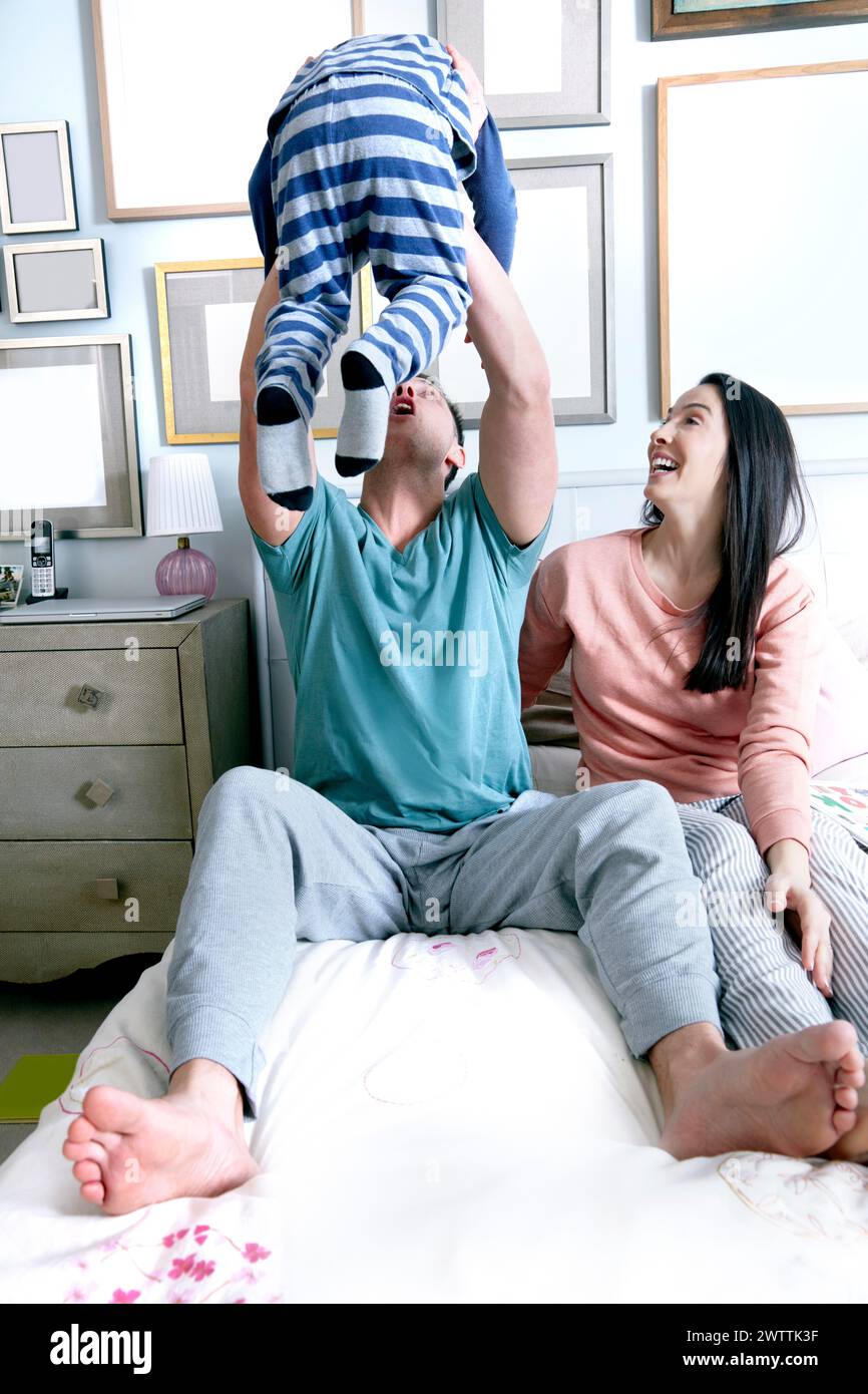 Family playing on a bed. Stock Photo