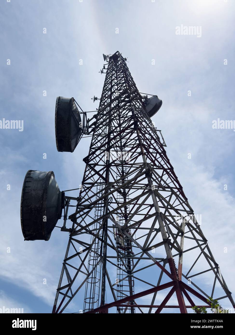 Metal radio antenna tower on blue sky background Stock Photo
