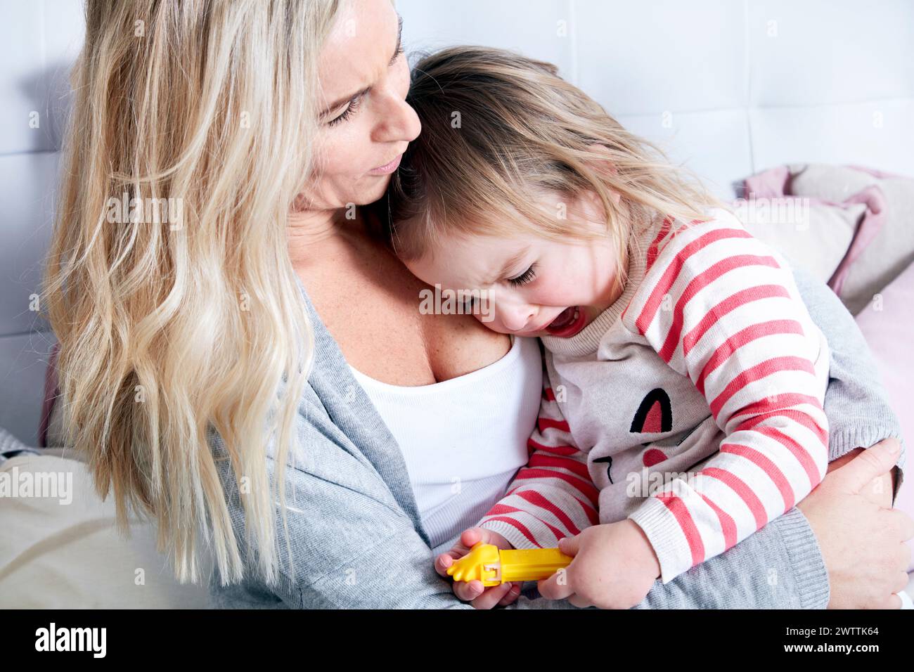 Mother comforting her crying child Stock Photo