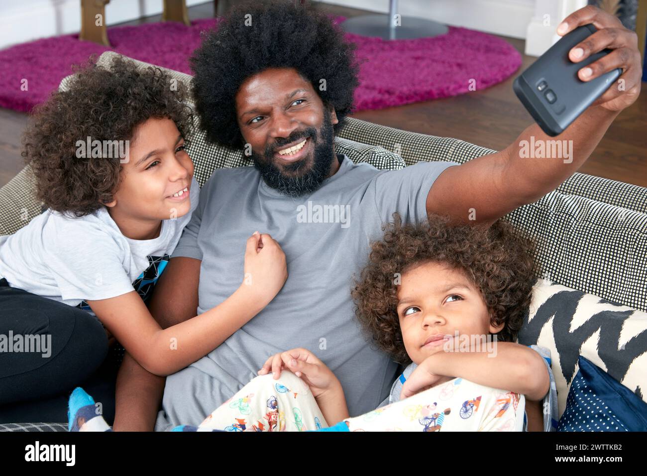 Family taking a selfie on a couch Stock Photo