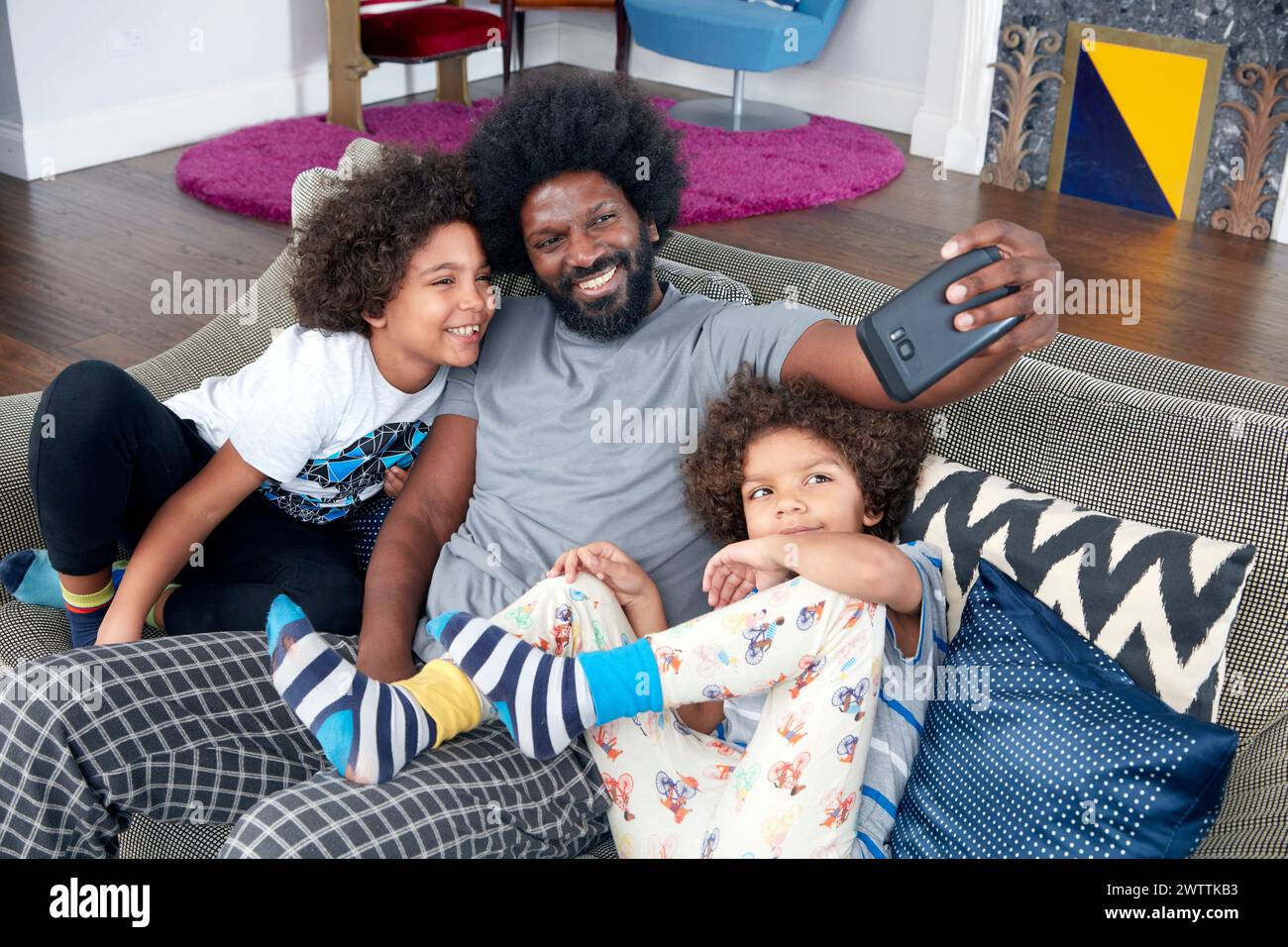 Family taking a selfie on the couch Stock Photo