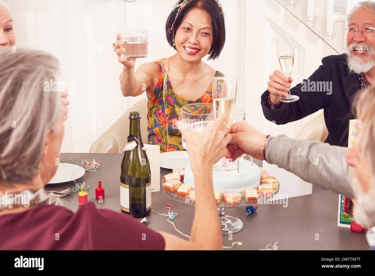 Family celebrating with a toast at a table Stock Photo