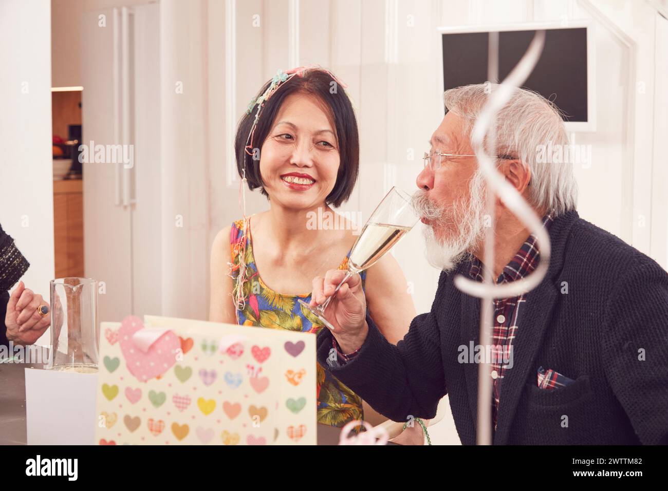Elderly man and woman celebrating with champagne Stock Photo