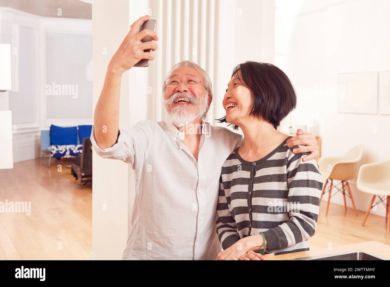 Elderly couple taking a selfie indoors Stock Photo