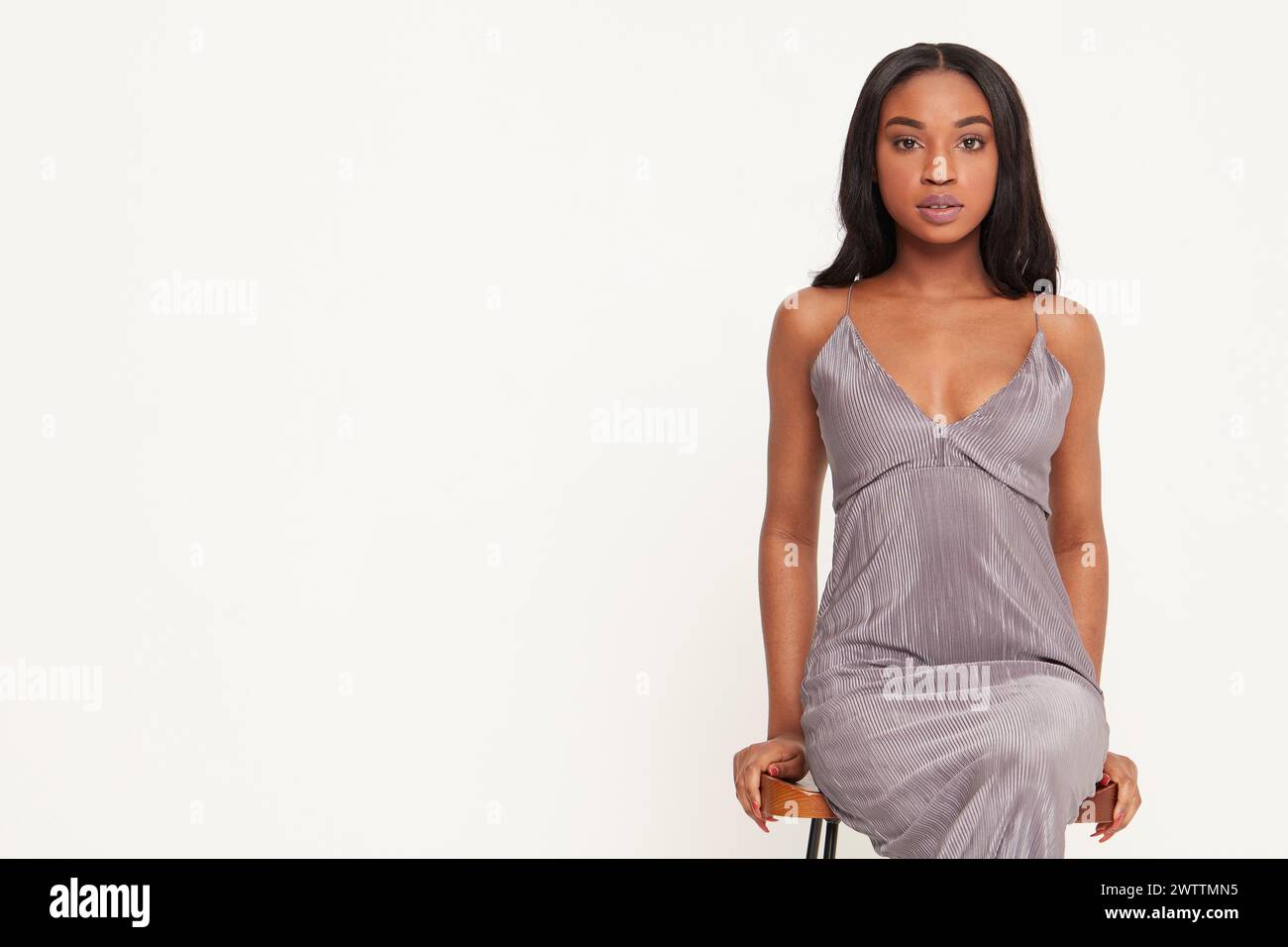 Woman posing in a grey dress Stock Photo