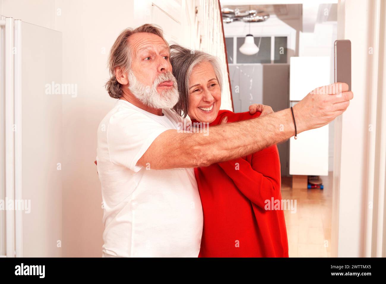 Senior couple taking a selfie at home Stock Photo