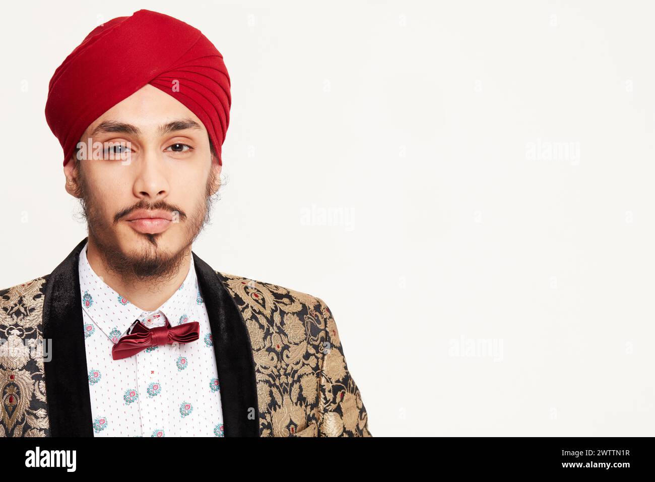 Man in traditional turban and patterned blazer Stock Photo