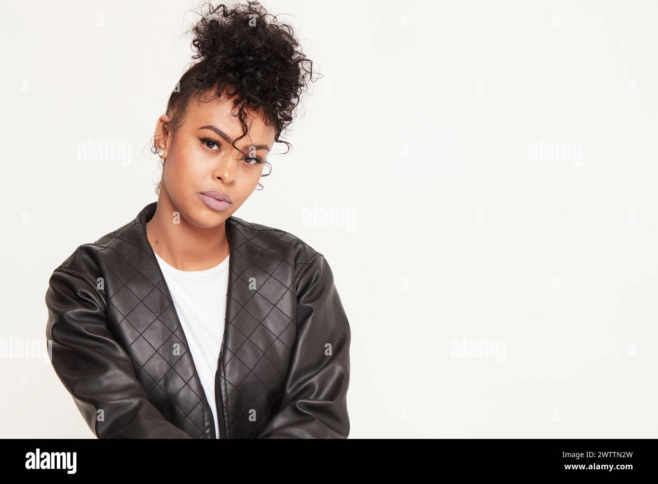 Confident woman posing in a leather jacket. Stock Photo