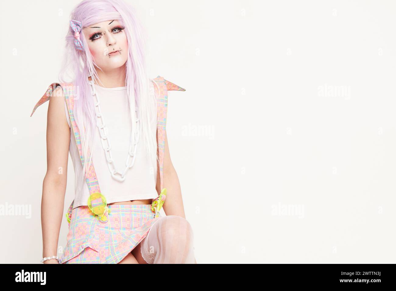 Woman in colorful attire with pastel hair Stock Photo