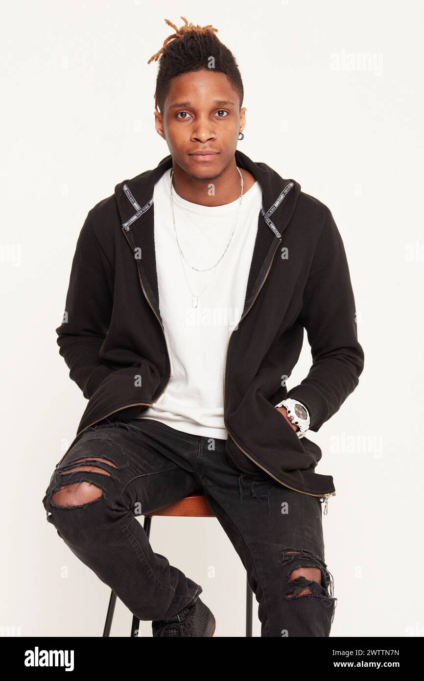 Young man posing in casual black attire. Stock Photo
