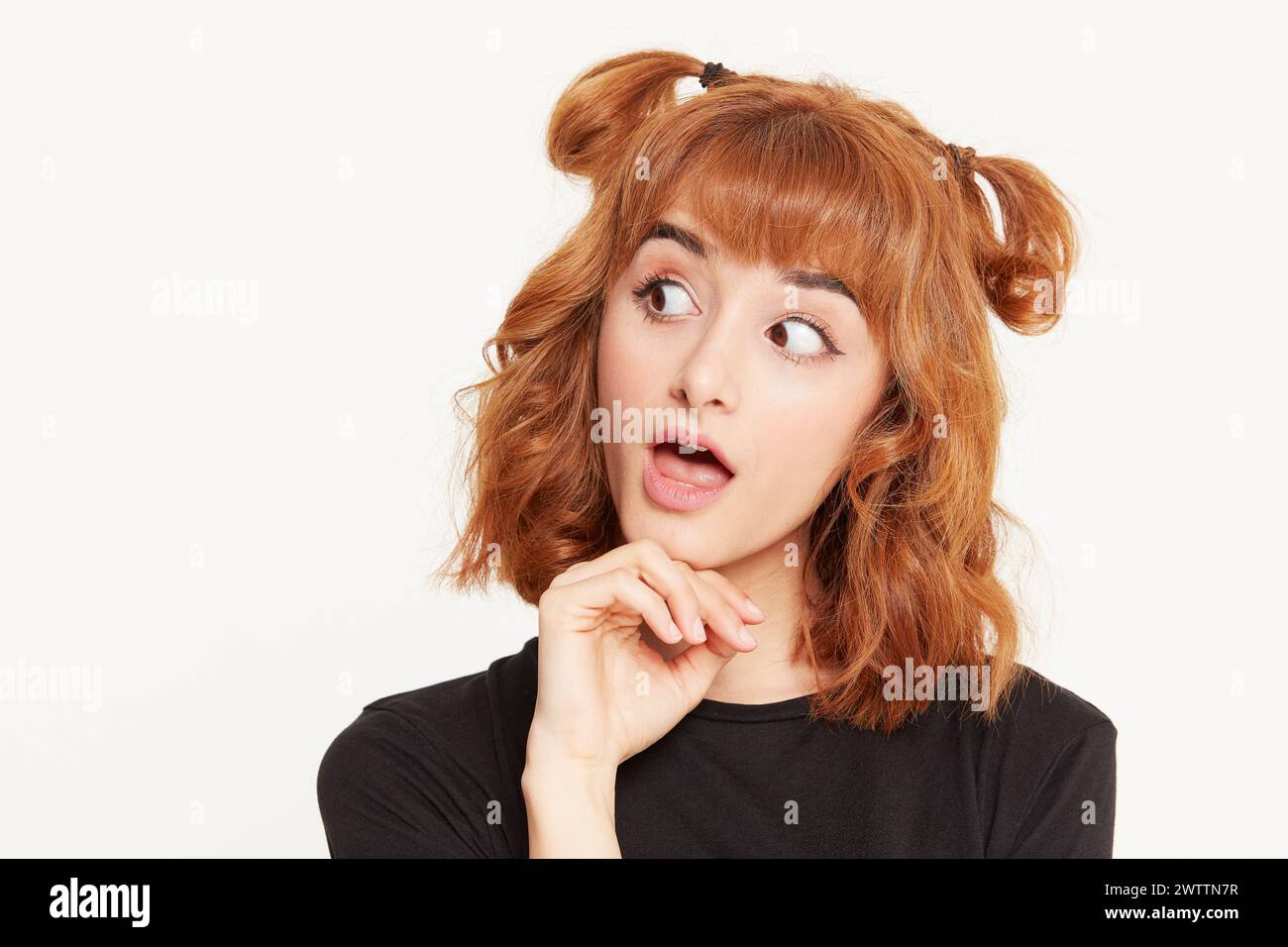 Woman with surprised expression and double buns hairstyle Stock Photo