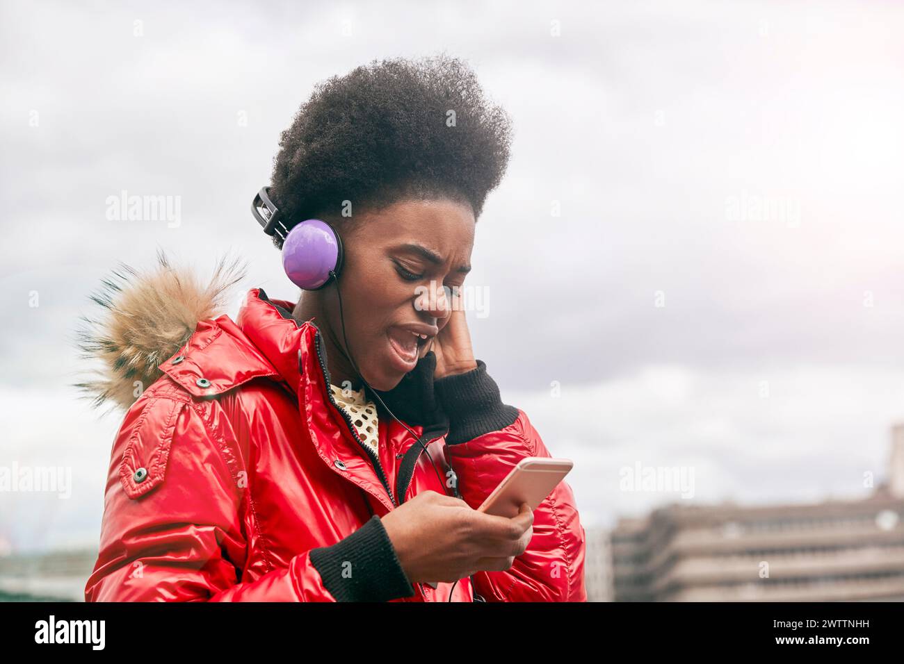 Woman with headphones using smartphone Stock Photo