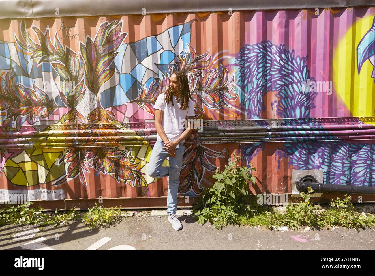Young man standing front wall hi-res stock photography and images - Alamy
