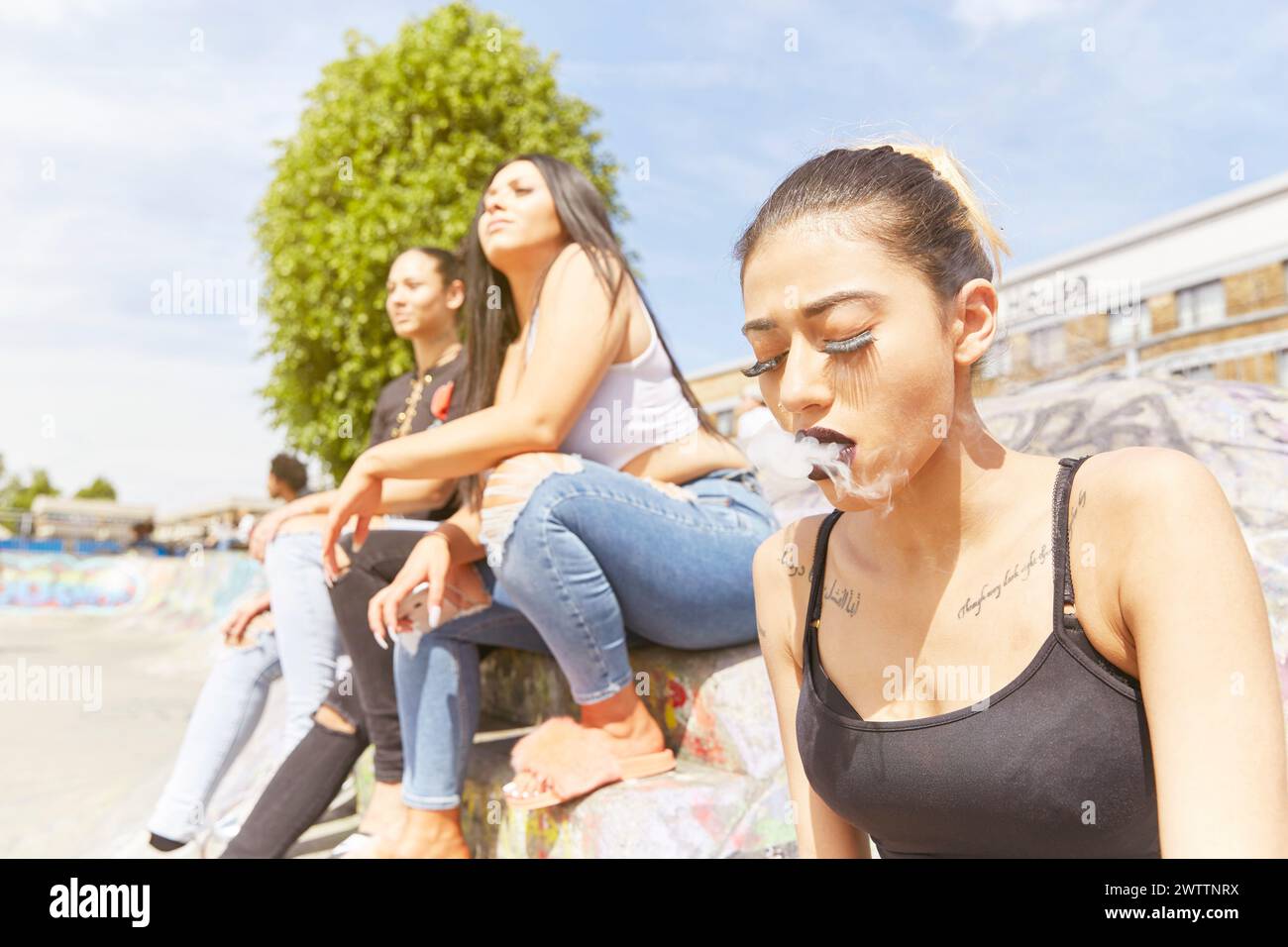 Three people relaxing on a sunny day Stock Photo