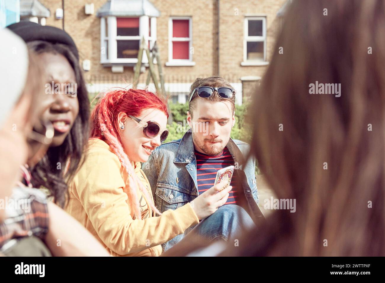 Friends gathered outdoors in casual attire Stock Photo