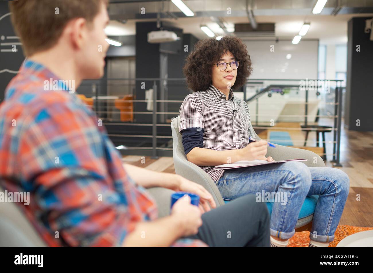 Colleagues in a casual office meeting. Stock Photo
