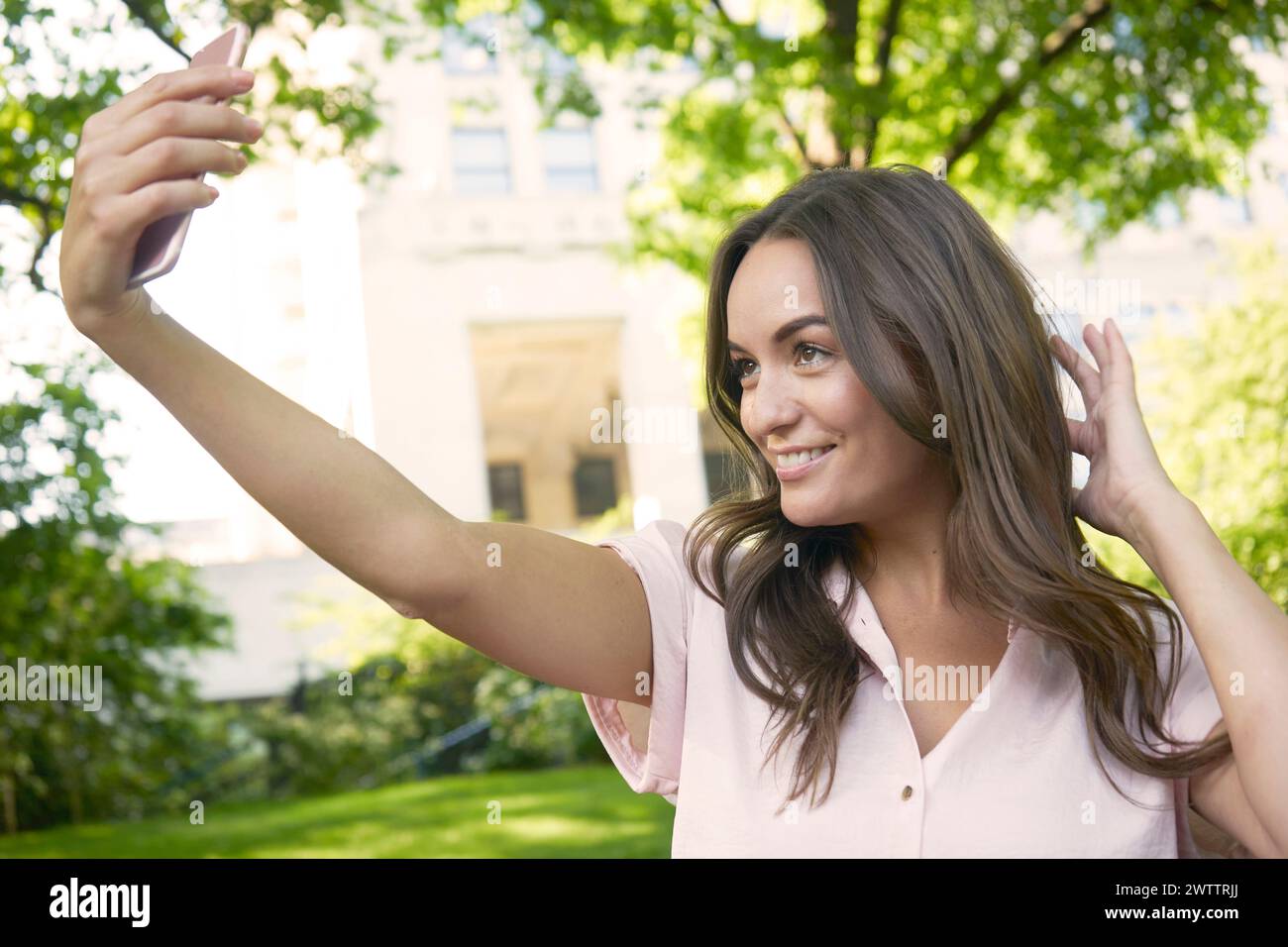 Woman taking a selfie outdoors Stock Photo