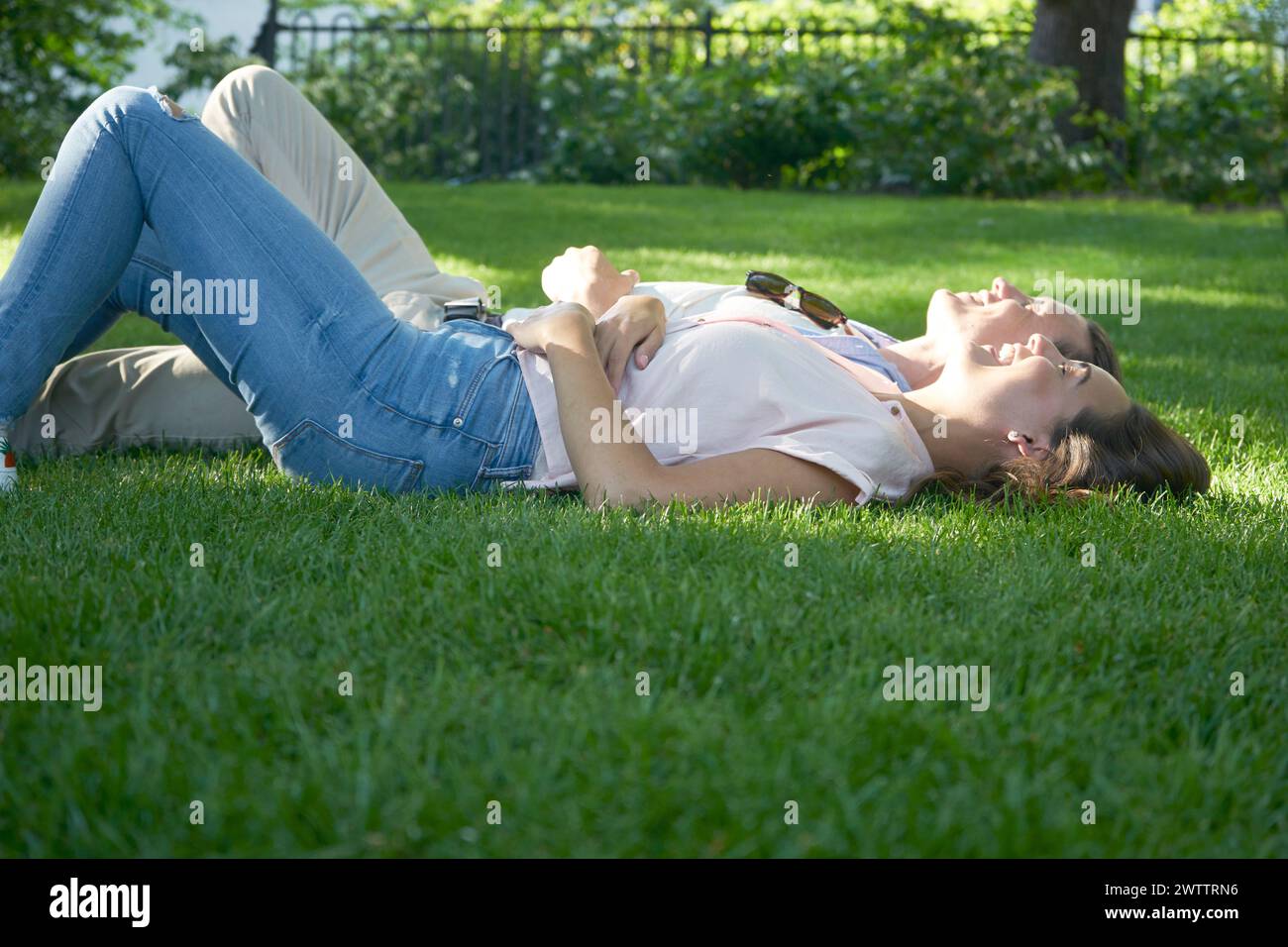 Two people relaxing on grass Stock Photo