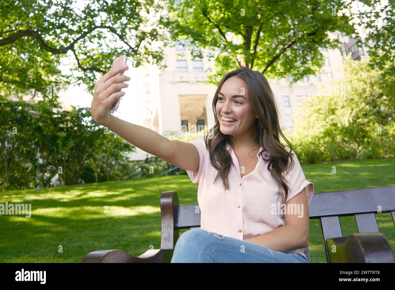 Young woman taking a selfie in the park Stock Photo