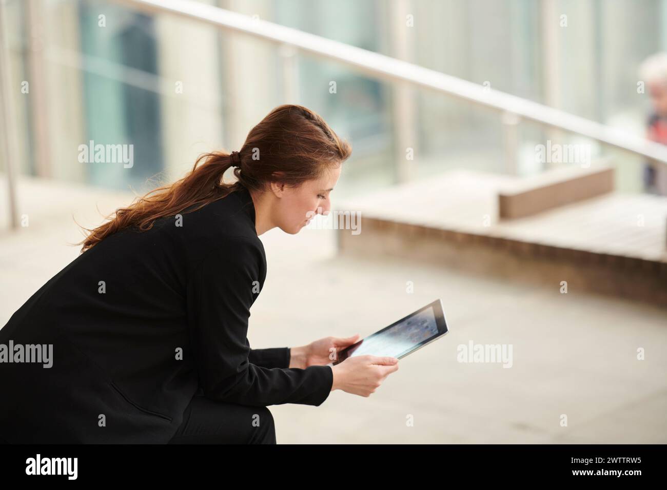 Businesswoman using tablet outdoors Stock Photo