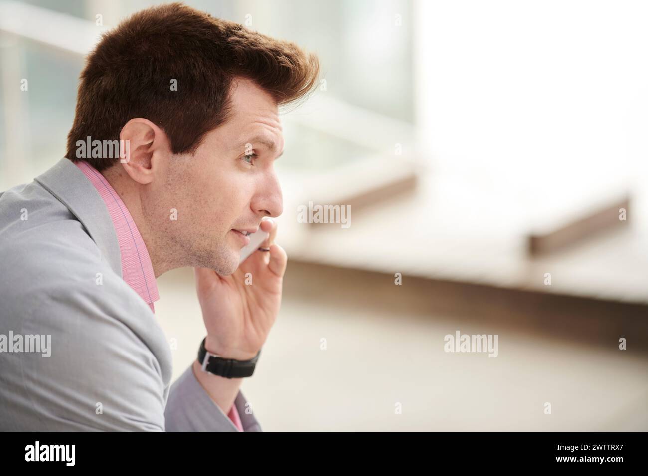 Man on a phone call looking thoughtful Stock Photo