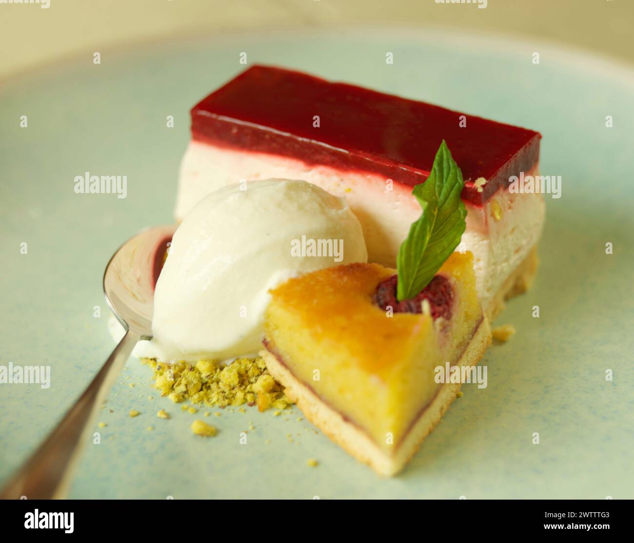 Slice of cheesecake with a scoop of ice cream on a plate Stock Photo