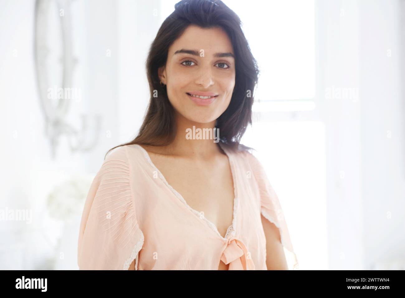 Smiling woman in a bright room Stock Photo
